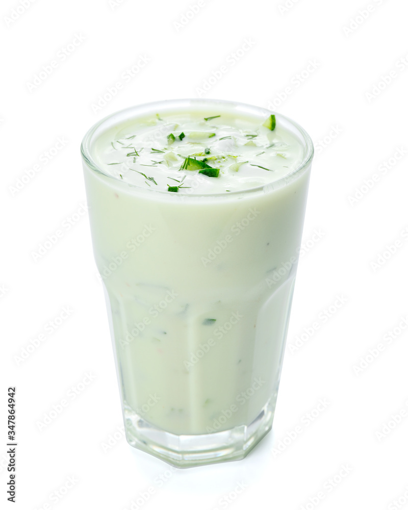 Glass with cold cucumber soup on white background Glass with cold cucumber soup on white background