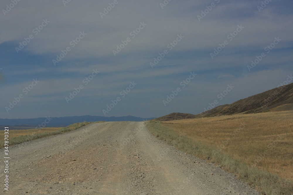 Empty dusty road in the steppe Empty dusty road in the steppe
