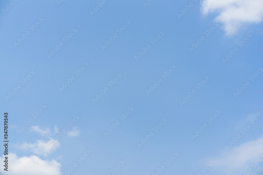 Blue sky with white soft clouds. Simple outdoor sky background. Blue sky with white soft clouds. Simple outdoor sky background.