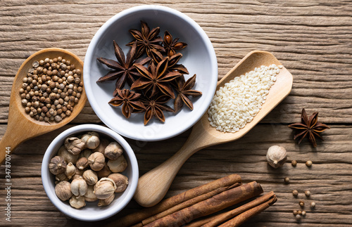 Variety of spices and natural herbs supplements health food on rustic table.