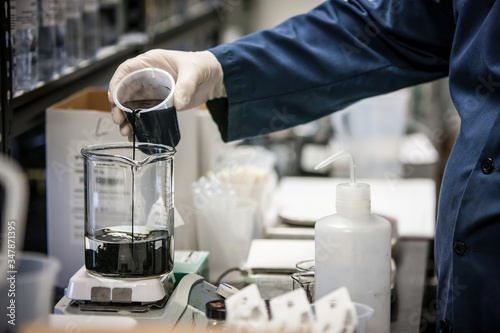 Laboratory Worker Pouring Beaker