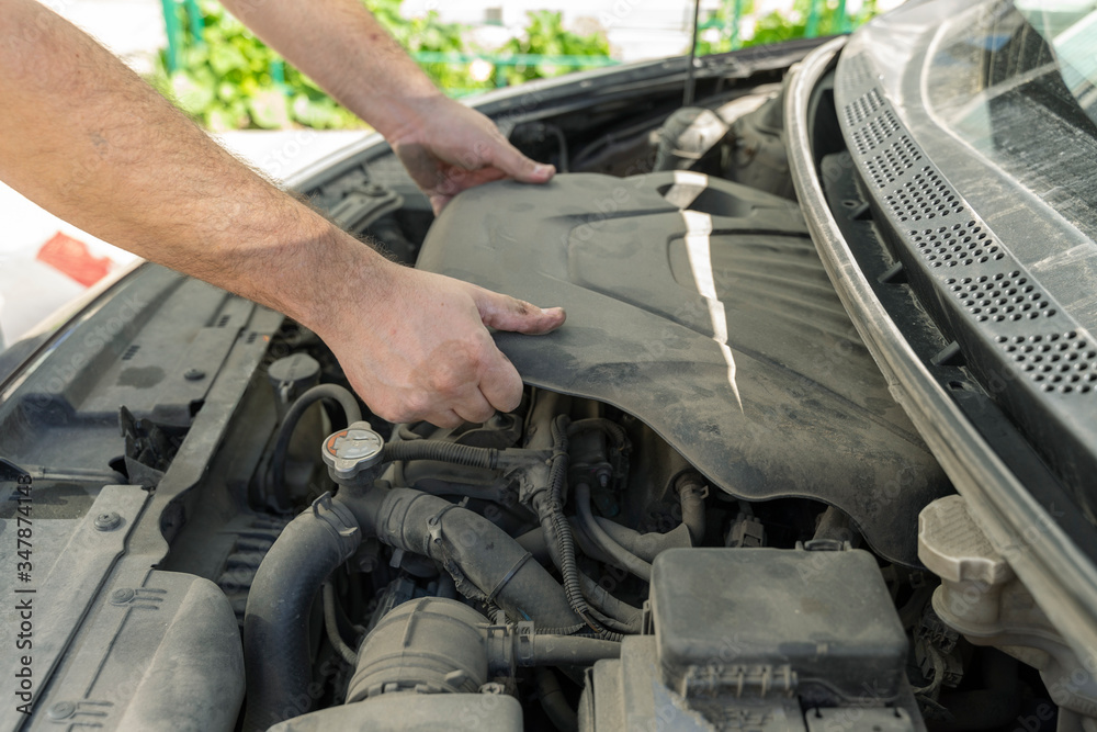 The car mechanic works in the garage. Repair. The car mechanic works in the garage. Repair.