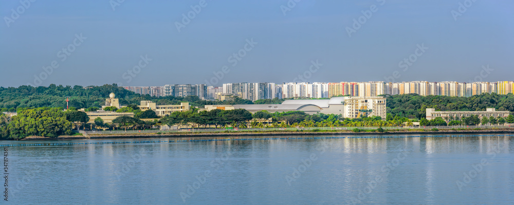 Panoramic sight of the Johor strait coast with Pasir Ris Coast Industrial Parks in Singapore with Punggol Town on the background.