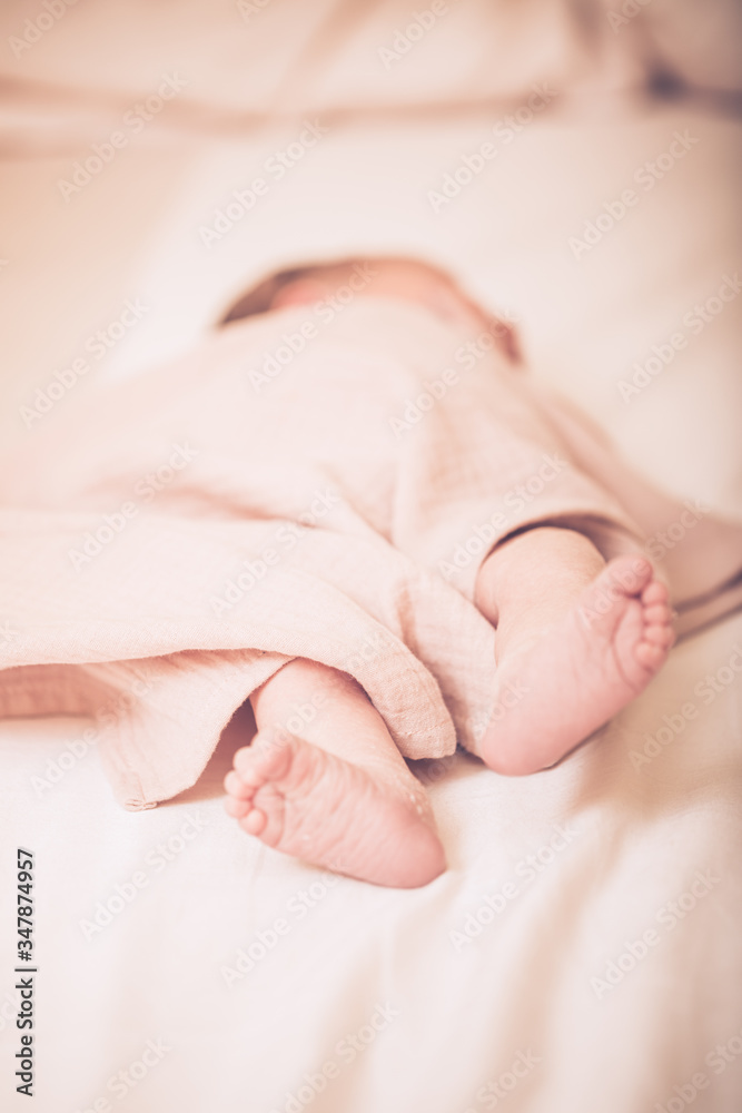 Close up picture of newborn baby feet. Sleeping newborn baby on a light blanket. Close up picture of newborn baby feet. Sleeping newborn baby on a light blanket.