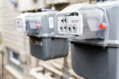 Φωτογραφία Row of gray natural gas meters at an apartment complex