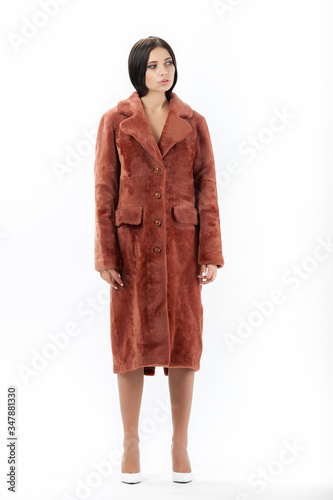 girl in a fur coat on a white background for a catalog