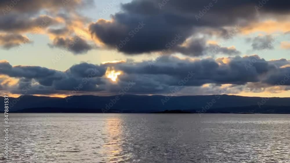 sunset over the mountains in the atlantic ocean in cloudy weather HD time-lapse sunset over the mountains in the atlantic ocean in cloudy weather HD time-lapse