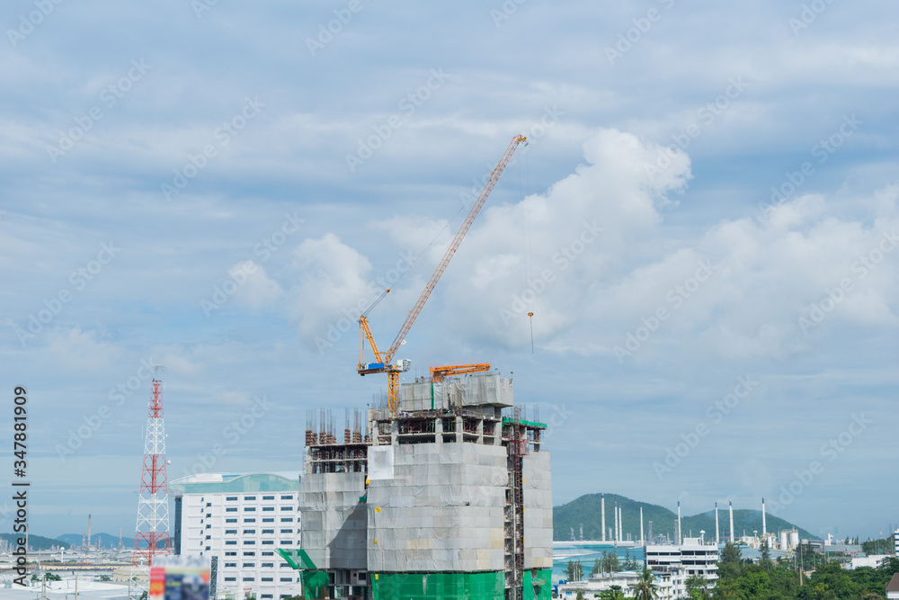 Building crane, engineering and building skyscraper under construction