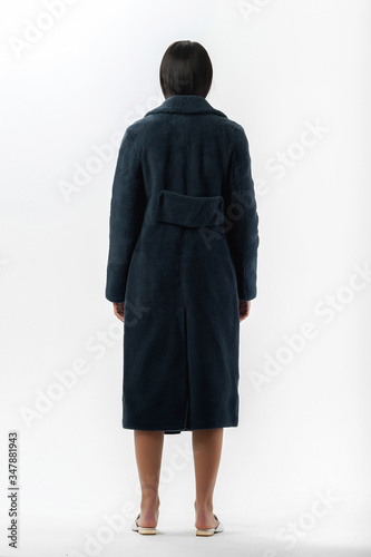 girl in a fur coat on a white background for a catalog