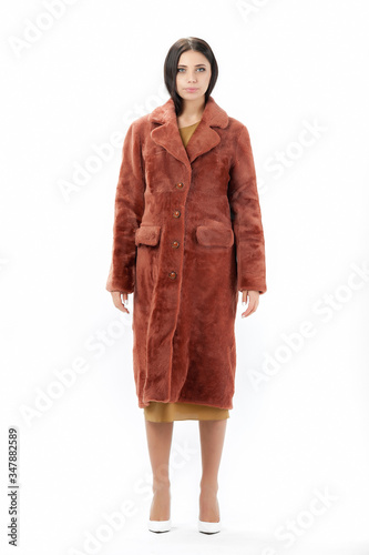 girl in a fur coat on a white background for a catalog
