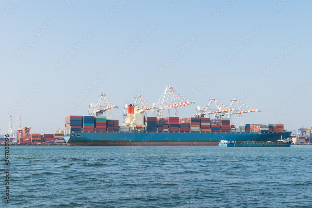 Big container ship and small container ship in asia port while load the job