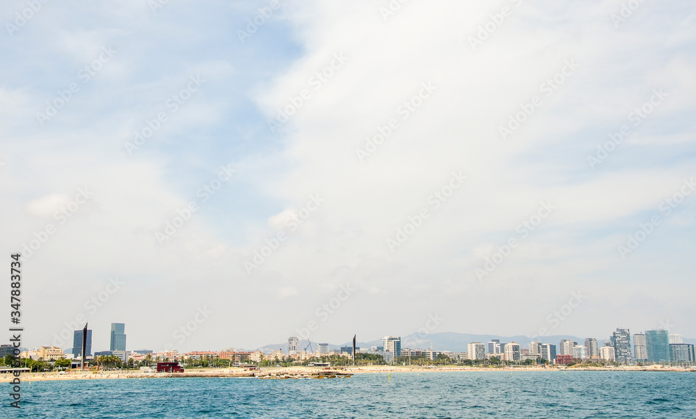 Barcelona waterfront skyline, Modern architectural landmarks and beach seen from the sea from the Mediterranean coast