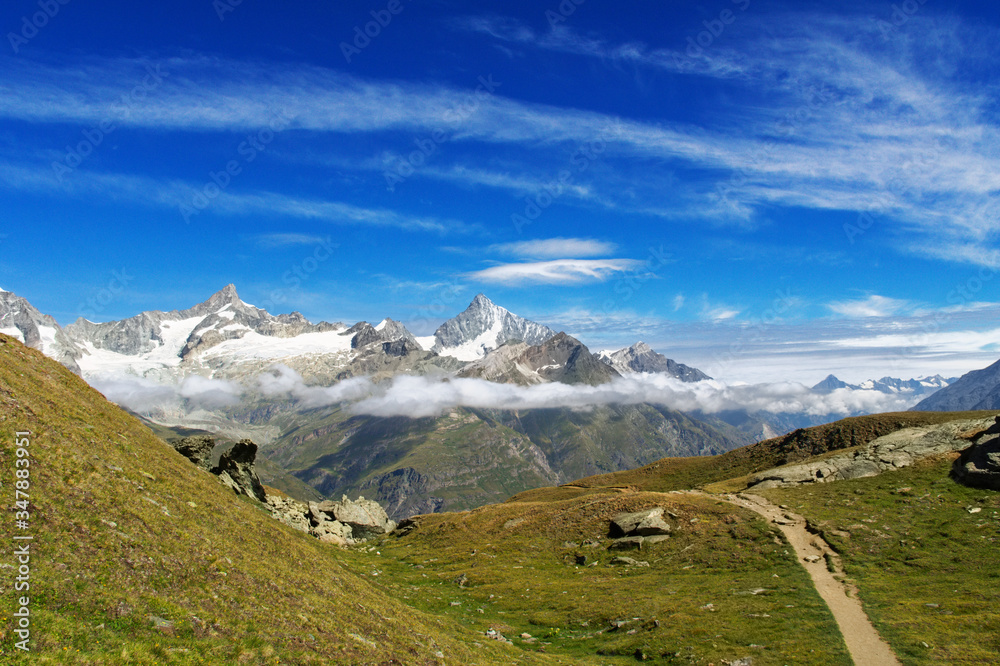 View of hiking trail in Swiss Alps, Zermatt Mountains area near Matterhorn Peak in summer, Switzerland
