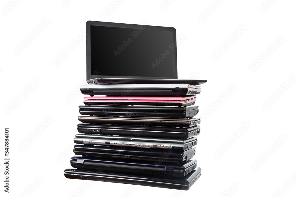 Stack of used laptops in different colors and models. T Stack of used laptops in different colors and models. T