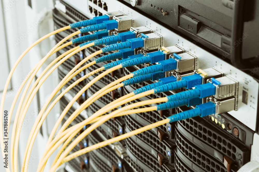 Communication equipment in the server room of the data center. Many fiber patch cords are connected to the interfaces of the Central Internet router. High-speed data transfer in a fiber-optic network