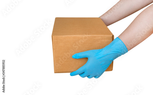 Hand wearing blue glove for protect allergic reaction or infectious diseases coronavirus/covid-19 holding paper box deliver goods to customer isolated on white background, clipping path included