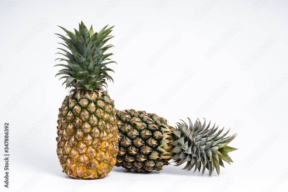 Whole fresh pineapple fruit on white background