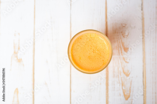 A glass of Orange juice on wood background