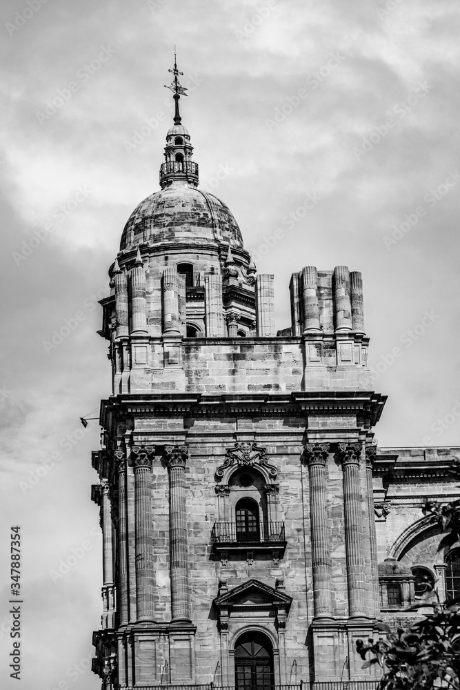 he unfinished tower of the Cathedral of Malaga in Andalusia, Spain in black and white