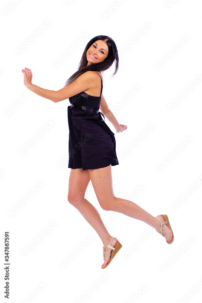 Young beautiful brunette in a black dress on a white background Young beautiful brunette in a black dress on a white background