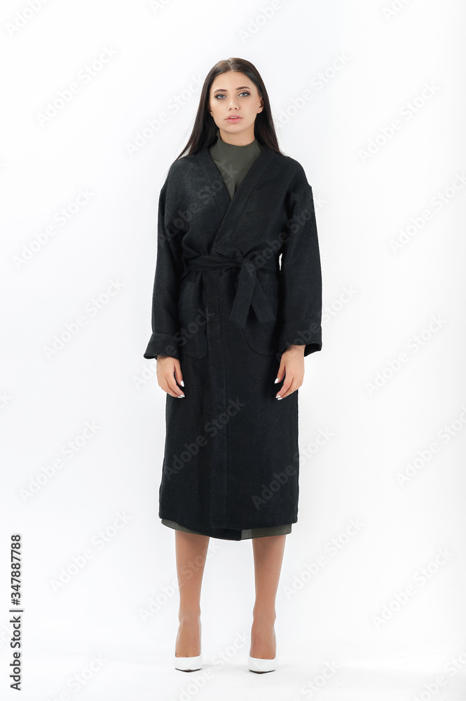 Fototapeta premium brunette posing in clothes for a catalog on a white background