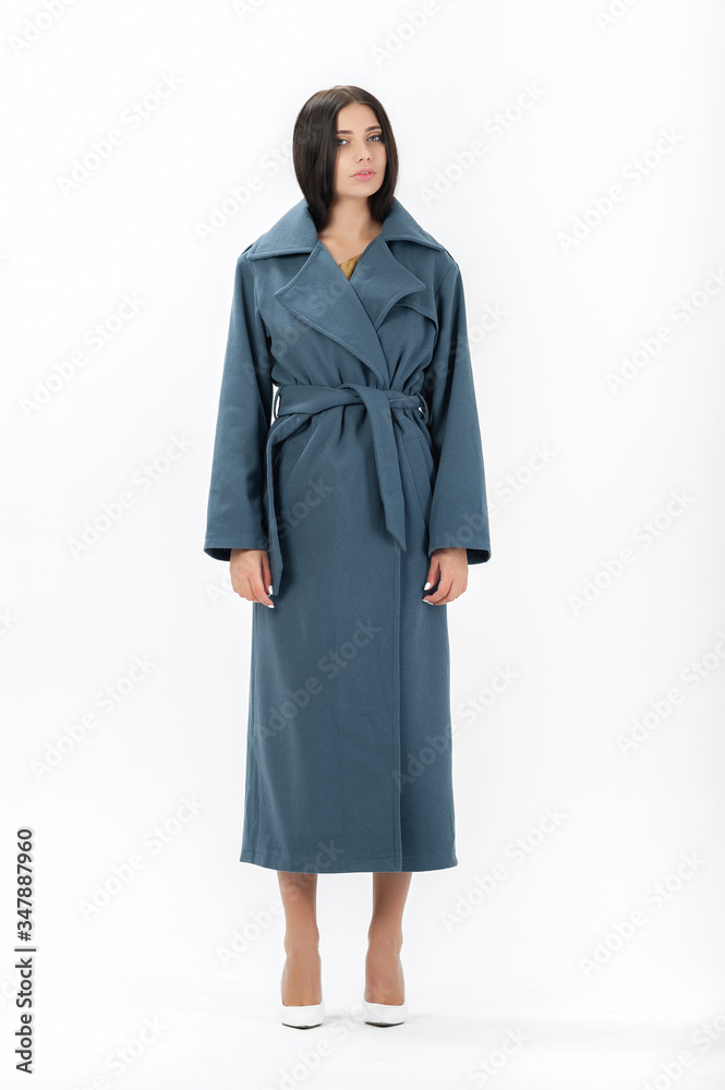 brunette posing in clothes for a catalog on a white background brunette posing in clothes for a catalog on a white background