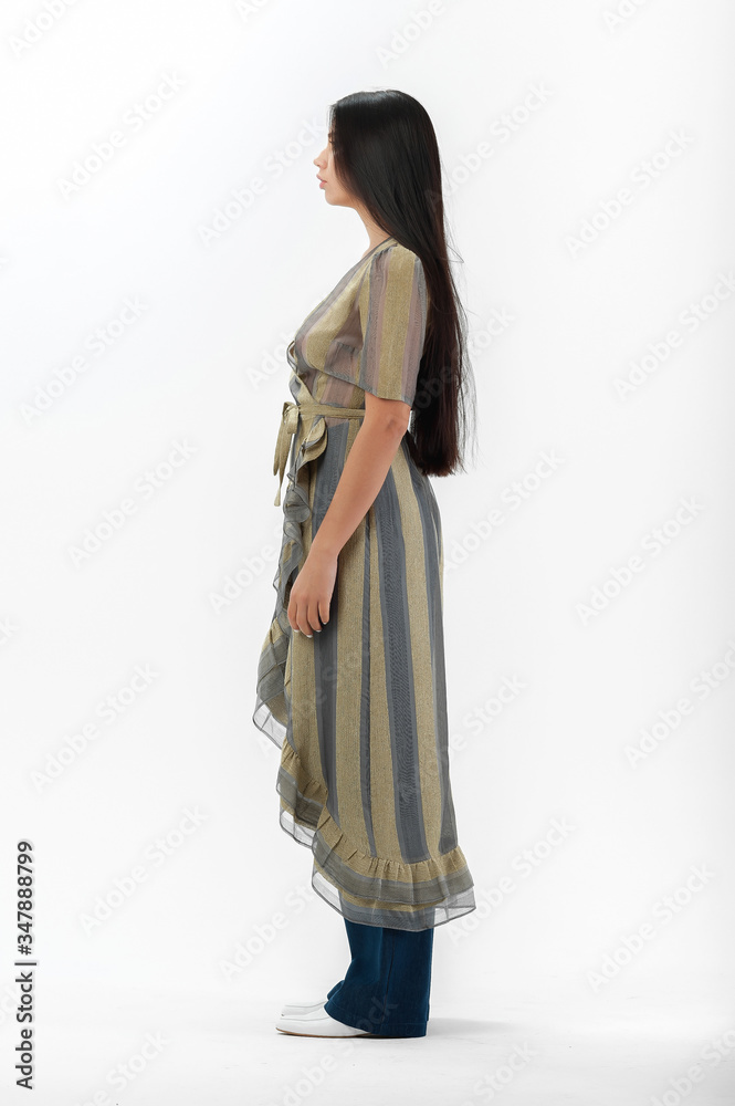 brunette posing in clothes for a catalog on a white background brunette posing in clothes for a catalog on a white background
