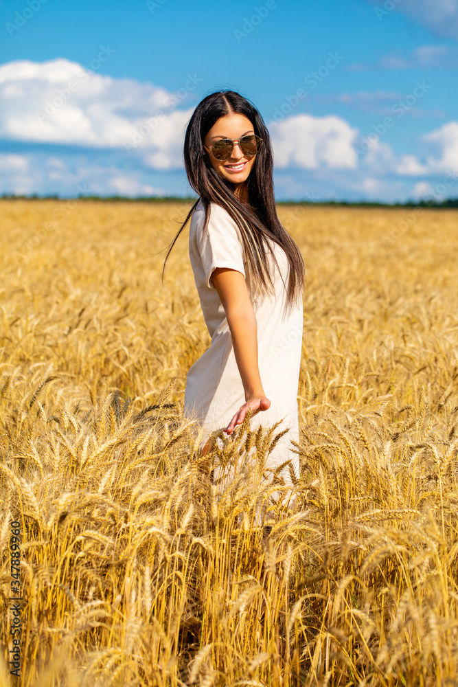Portrait of a young woman in sunglasses with specular glasses in which white clouds are reflected Portrait of a young woman in sunglasses with specular glasses in which white clouds are reflected