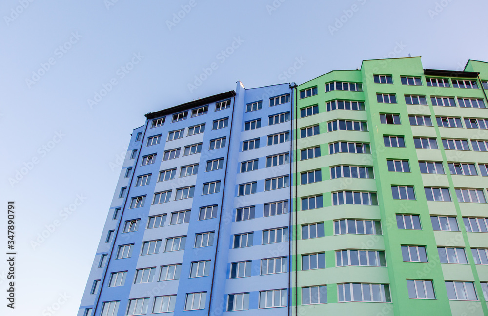 Fototapeta premium New-constructed multi-storey residential building. multi-storey residential house in brown and beige colors. Modern residential construction. Residential fund