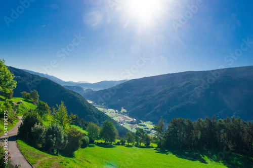 mountain valley with stones and meadows above, lush forests below and below rivers and villages © pmmart