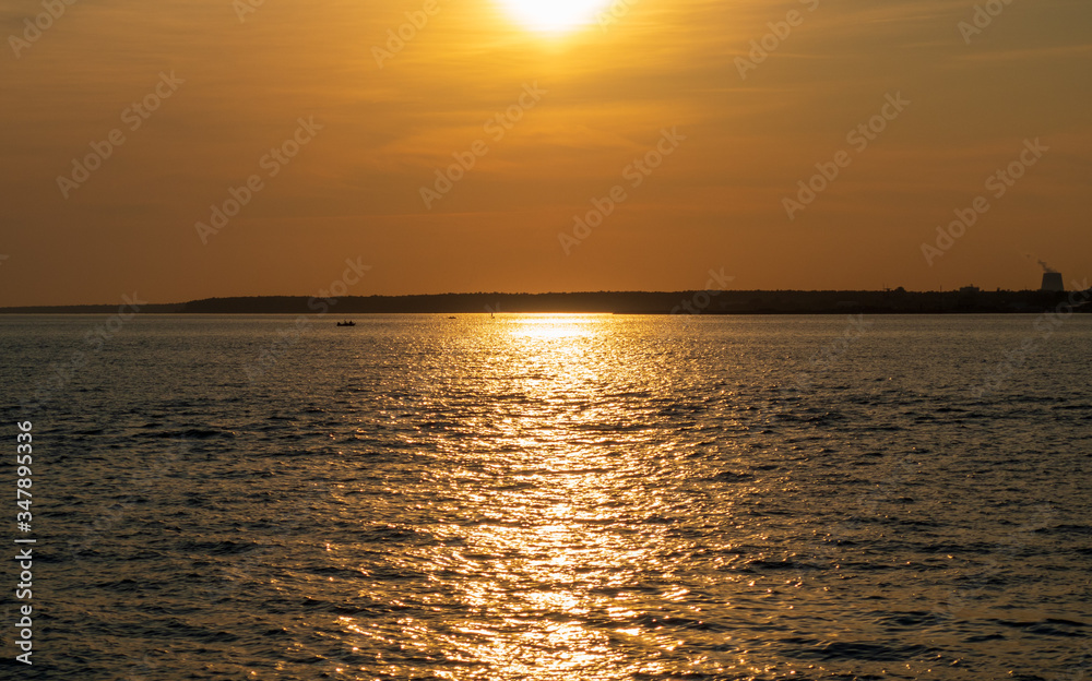 Scenic sunset over the sea. Reflection of the sun in water