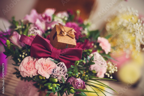 bouquet of roses and wedding rings