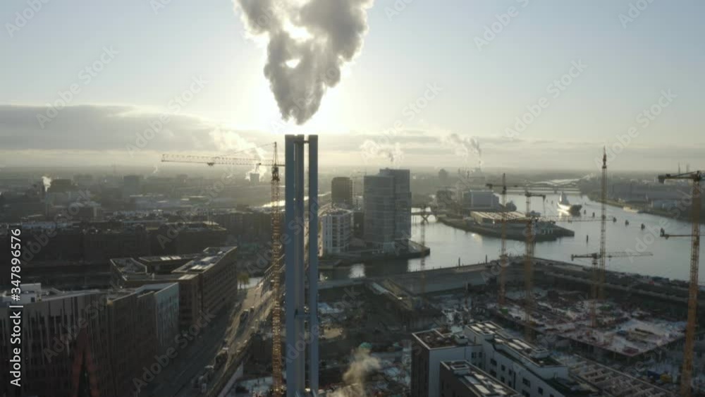 Huge construction site and industry chimney in Hamburg City at the flow