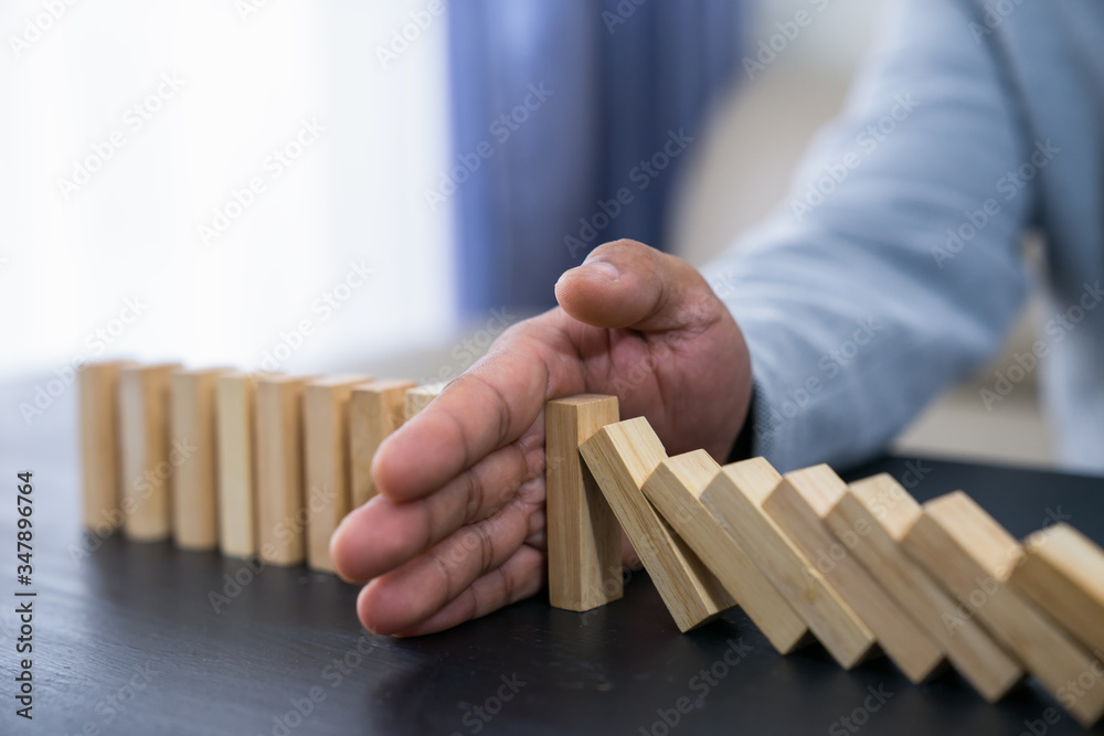 Stopping the domino effect concept for business solution, strategy and successful intervention