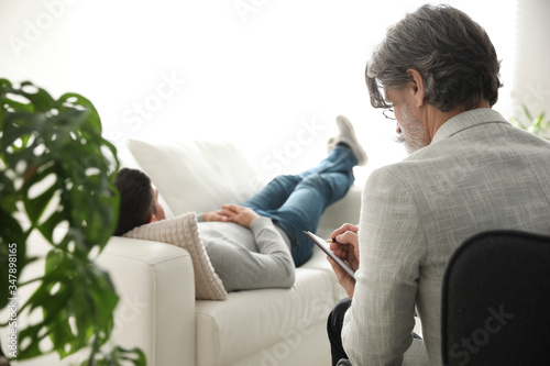 Psychotherapist and patient in office. Hypnotherapy session photo