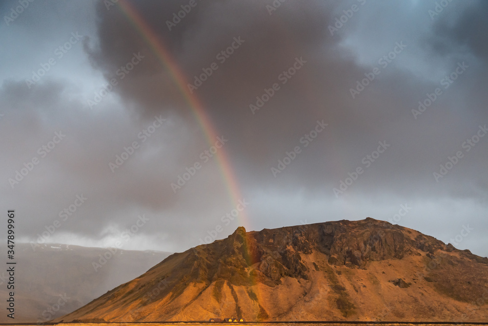 A rainbow and golden light after a winter storm in south Iceland