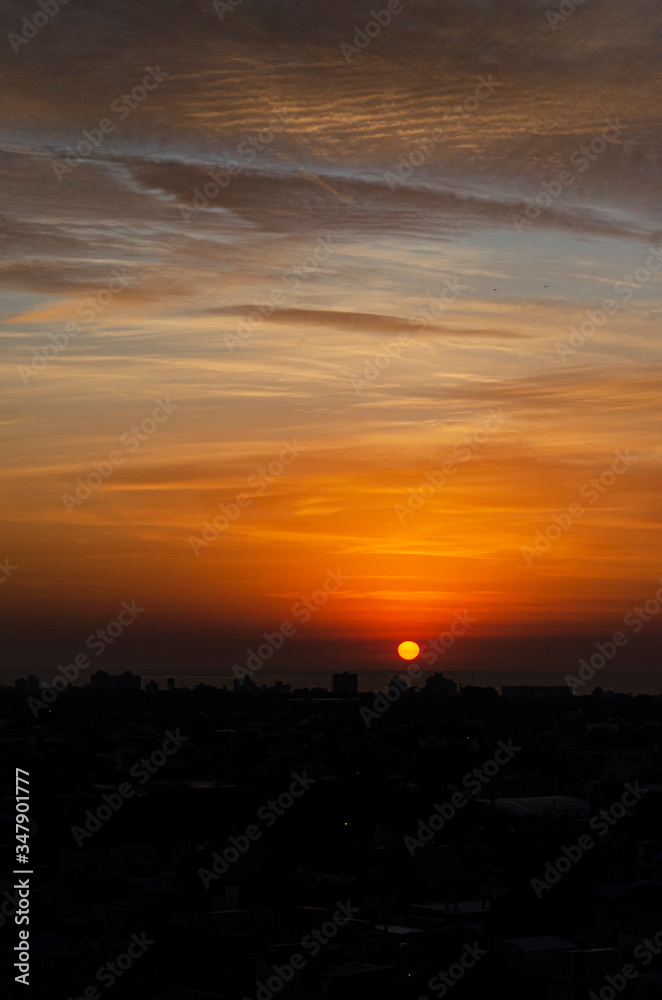 sunrise over the sea with city silhouette. sunrise over the sea with city silhouette.