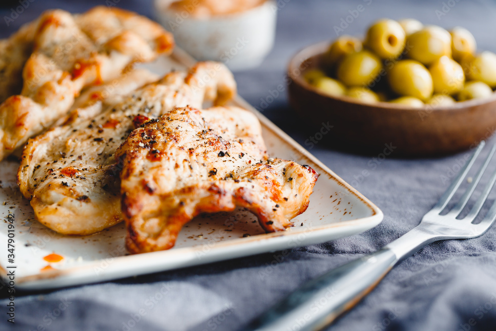 Grilled turkey escalopes with hot sauce on a table. Grilled turkey escalopes with hot sauce on a table.