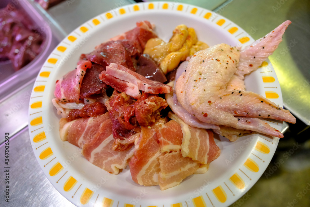 Close up raw slice pork chicken wings ,liver in plate prepare for barbecue. Close up raw slice pork chicken wings ,liver in plate prepare for barbecue.
