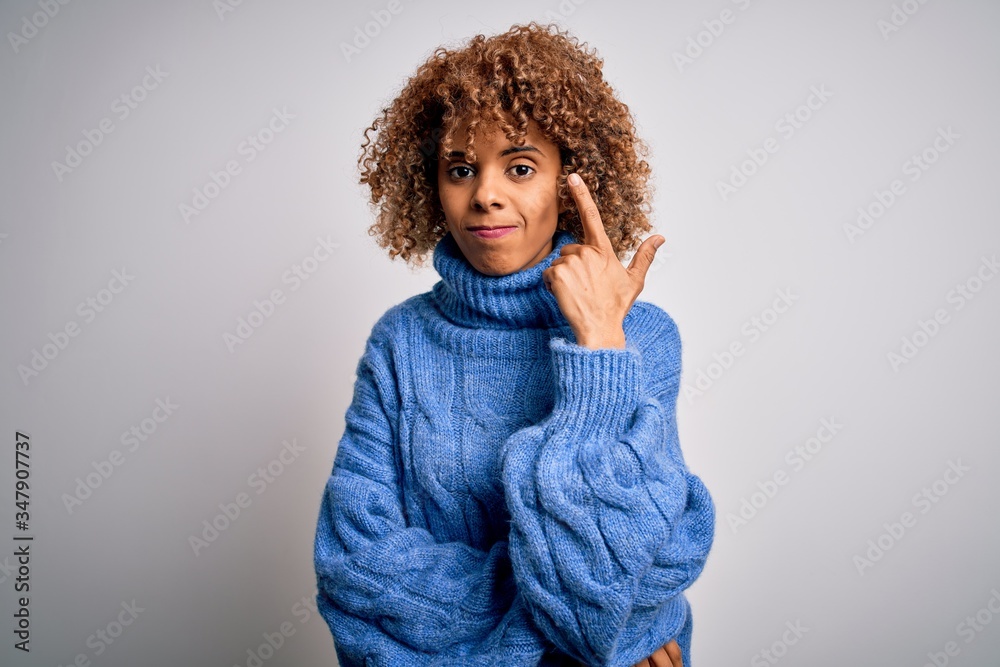 Young beautiful african american woman wearing turtleneck sweater over white background Shooting and killing oneself pointing hand and fingers to head like gun, suicide gesture. Young beautiful african american woman wearing turtleneck sweater over white background Shooting and killing oneself pointing hand and fingers to head like gun, suicide gesture.