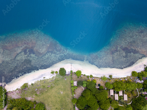 Lombok, Indonesia, south Gili islands. Aerial drone view from Gili Asahan island. .A strip of sand on the beach and blue sea with corals.