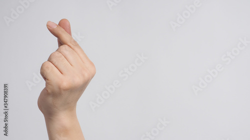 Male model is doing mini heart hand sign on white background.
