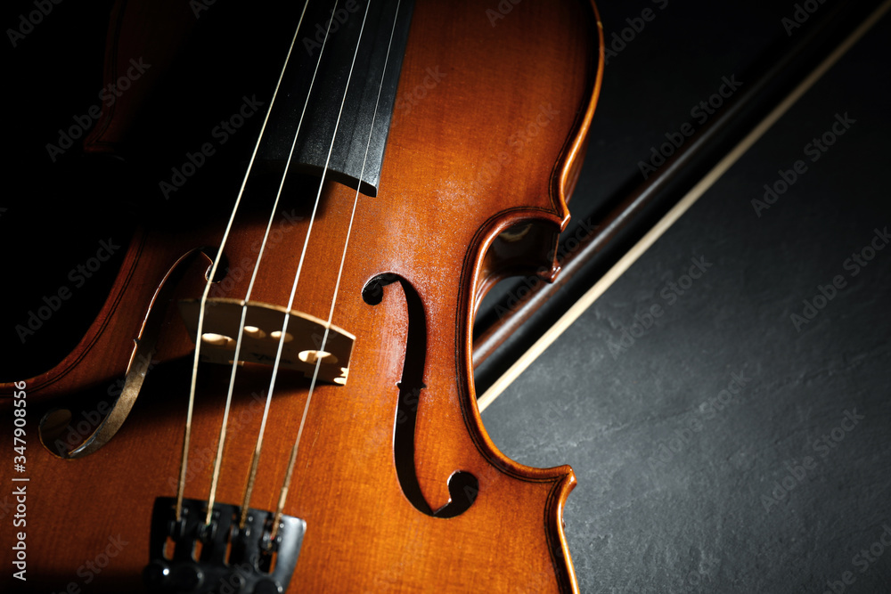 Classic violin and bow on stone table, closeup Classic violin and bow on stone table, closeup