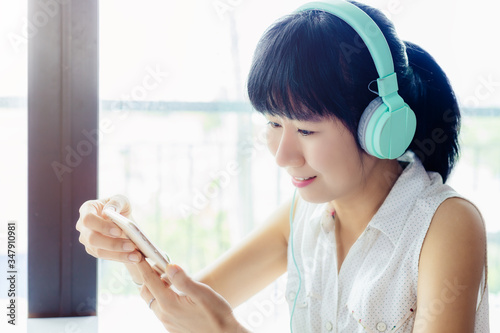 Asian smiling woman wearing...