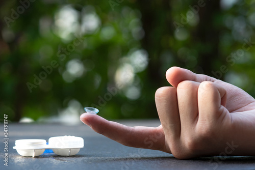 contact lens on finger and  white case