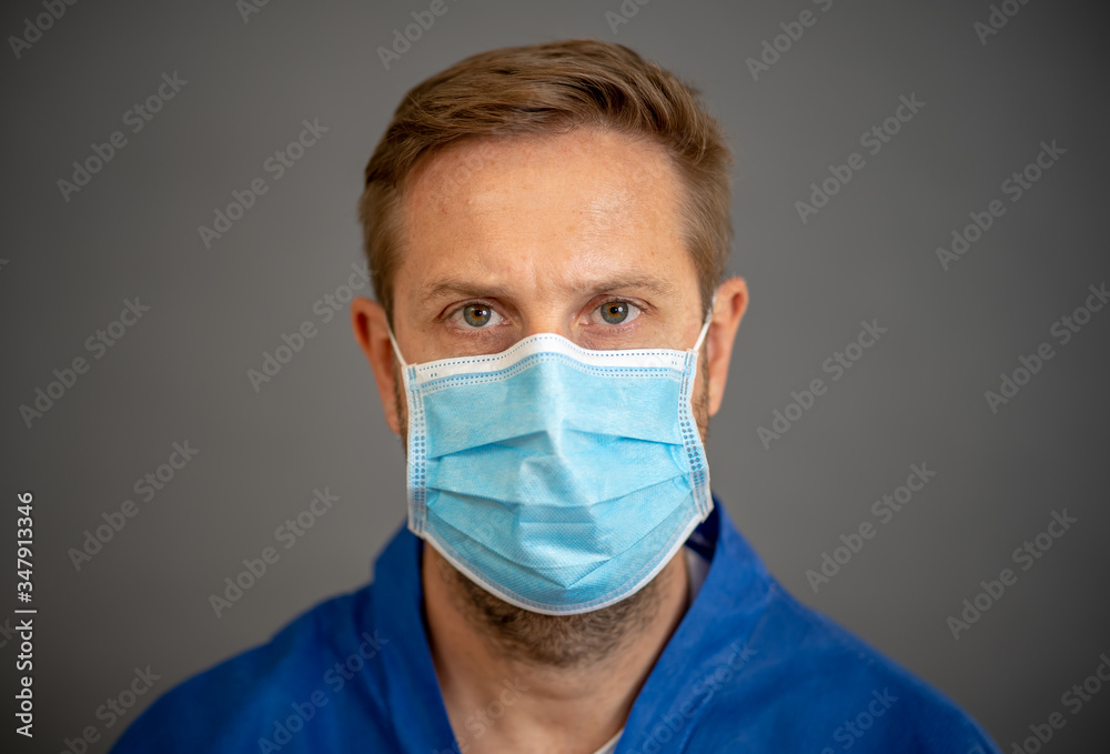 Male Doctor or Nurse Wearing Protective face medical Mask. Save lives from Covid-19 Outbreak Male Doctor or Nurse Wearing Protective face medical Mask. Save lives from Covid-19 Outbreak
