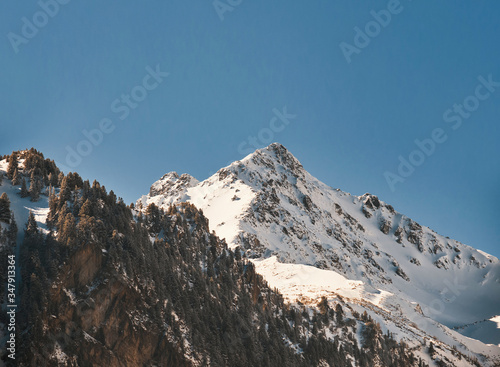 Snowy mountain top on the blue sky