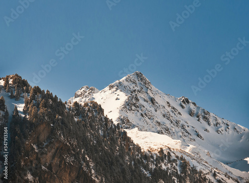 Fototapeta Naklejka Na Ścianę i Meble -  Snowy mountain top on the blue sky