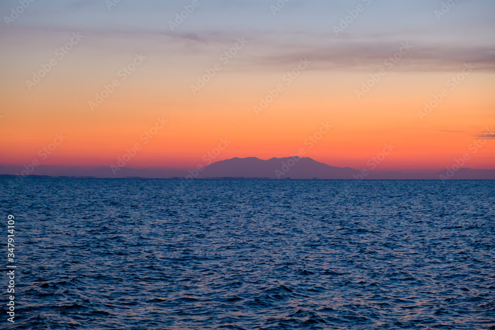 Colorful orange sunset over a island 