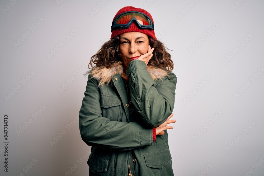 Middle age skier woman wearing snow sportswear and ski goggles over white background thinking looking tired and bored with depression problems with crossed arms.
